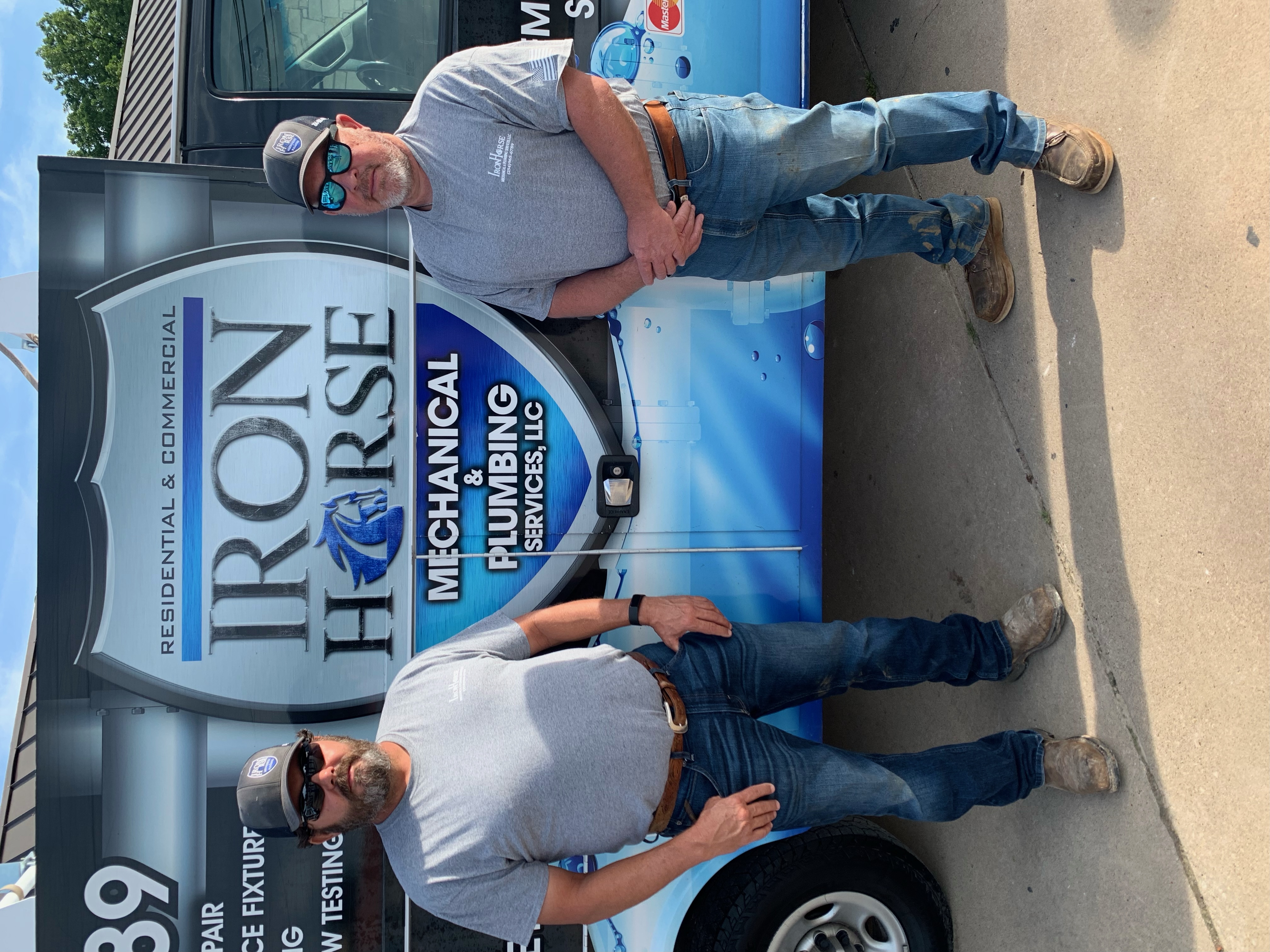 Co-founder Shawn Chaviers and Master Plumber Harold "Junior" Ferguson, owners of Iron Horse Mechanical & Plumbing Services, standing beside their service truck in Stephenville, Texas